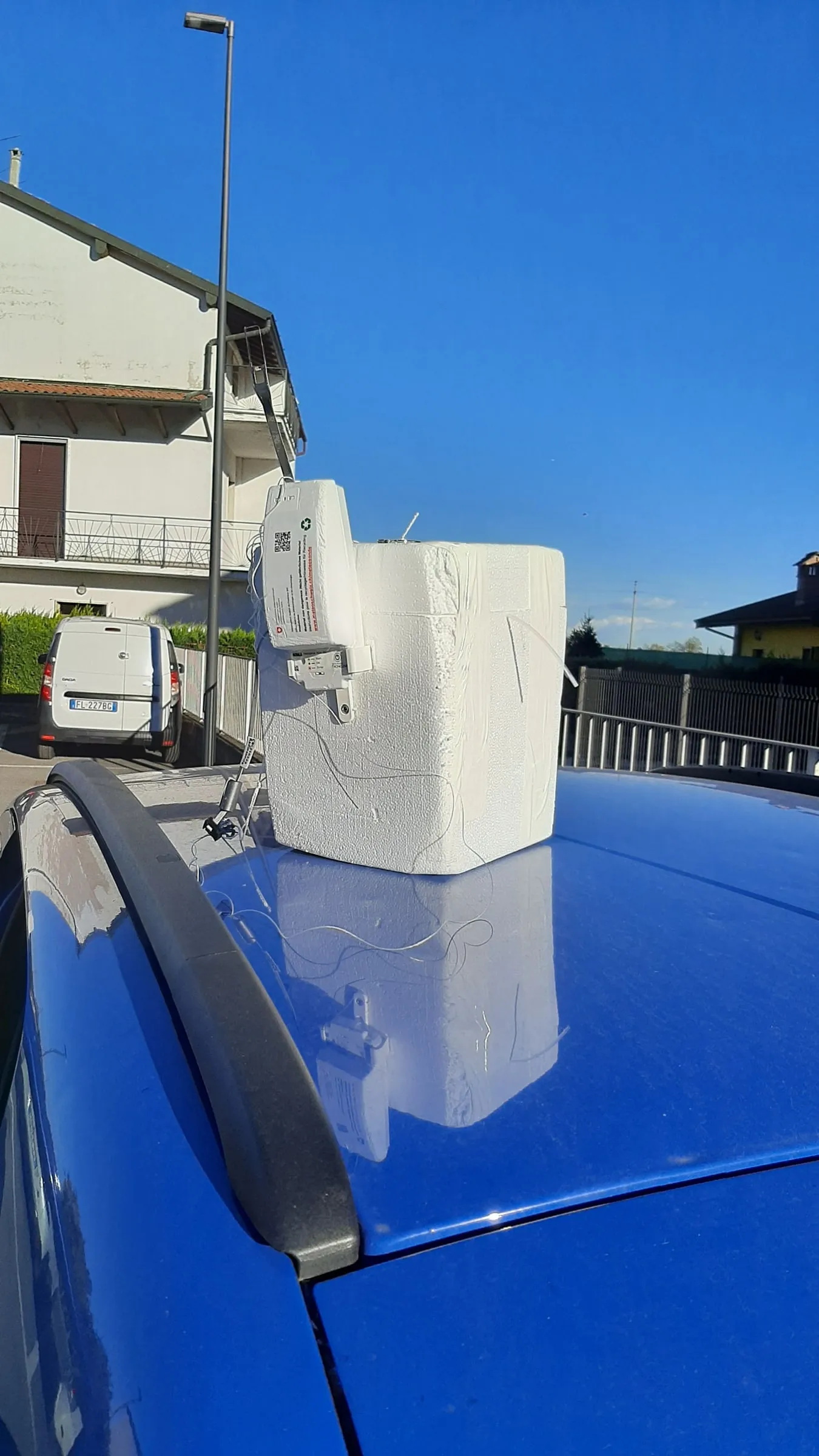 A radiosonde with an ozone sensor, resting on the roof of a car