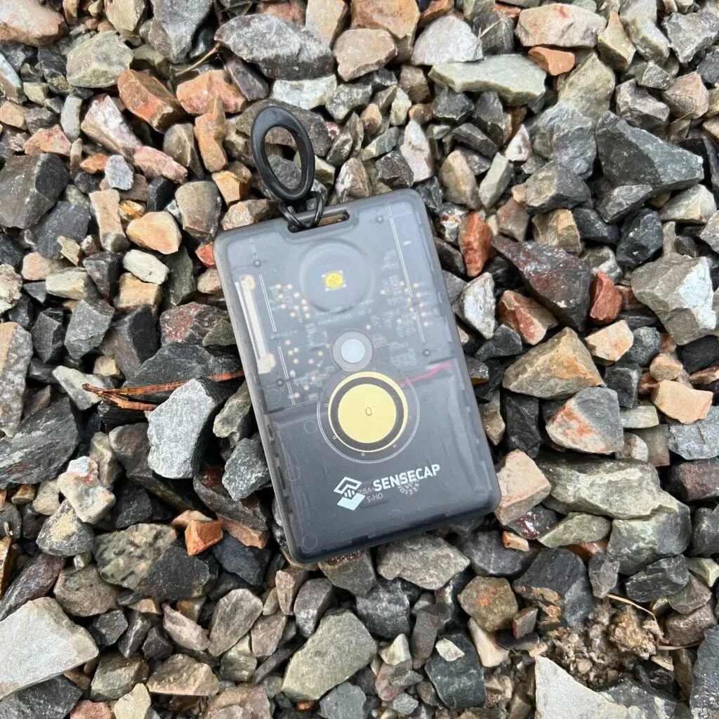 The black pocket card, lying on stones